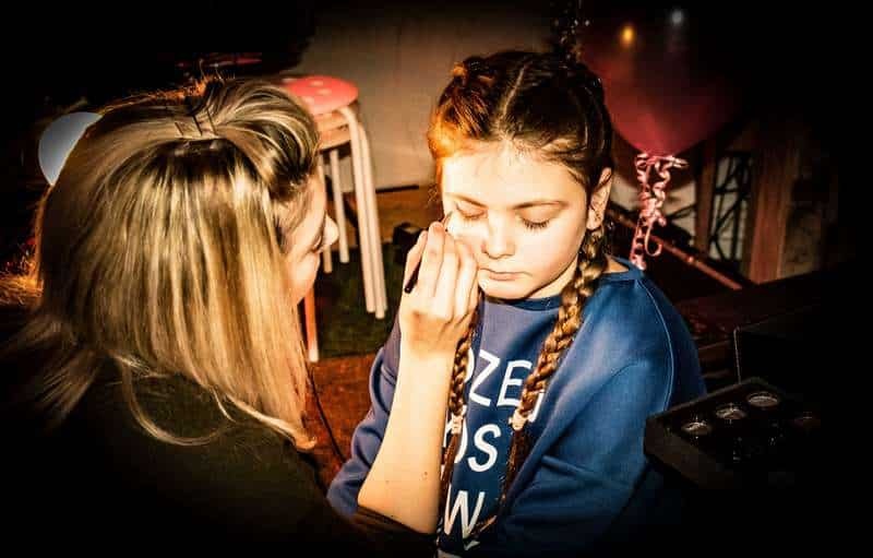 Party host with birthday girl doing festival makeup
