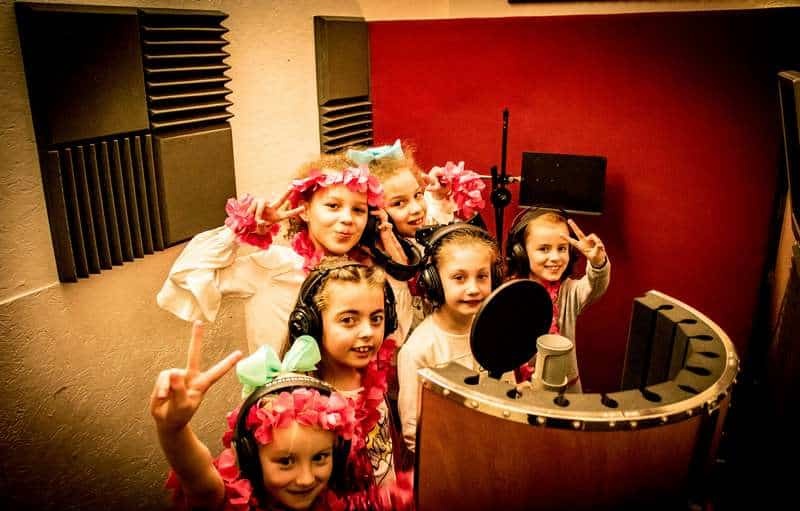 Party guests smiling in vocal booth